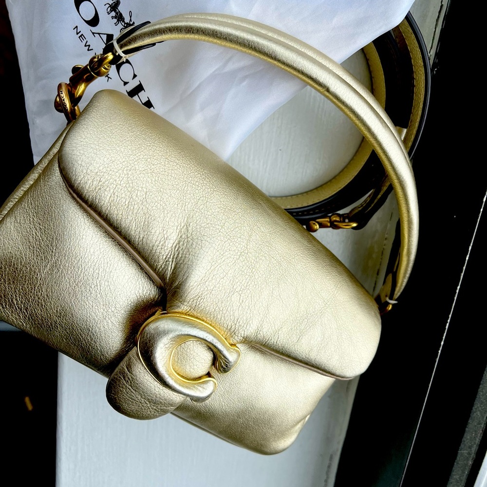 The Petite Pillow Tabby is designed w/ plush, ultra-soft metallic leather.